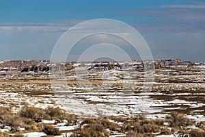 Open snow covered valley in New Mexico desert with rocky hills