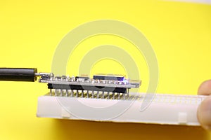 Open source firmware used in making IOT prototype projects connected to breadboard on white background