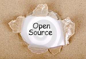 Open source word written on torn paper