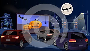 Open space auto theater. Drive-in cinema. Open-air cars are watching a movie on the movie screen. Halloween concept