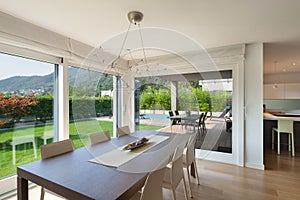 Open space of luxury house, dining table