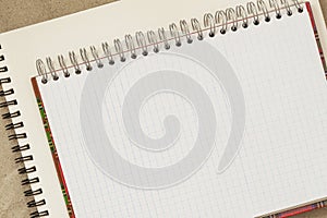 Open spiral bound notepad on background of scrapbook, copy space