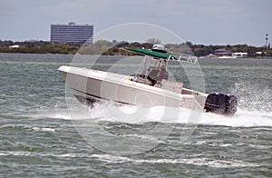 Open sport fishing boat powered by two outboard engines