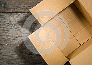 Open square cardboard box on the background of the old wooden table.