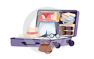 Open suitcase with clothes and shoes folded in neat order, packing family things