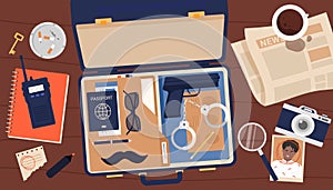 Open suitcase of detective or secret agent, top view of investigators secret desk