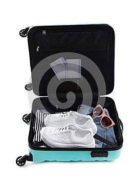 Open suitcase packed for travelling