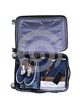 Open suitcase packed for travelling on white background