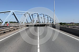 The road with a swing bridge in zeeland, the netherlands in summer photo