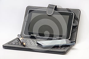 Open tablet with keyboard and Android mobile phone