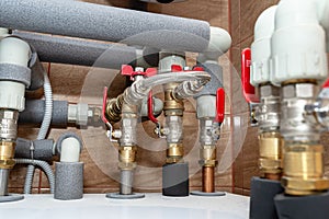Open three-quarter inch valves attached to the heat pump installation, plastic elbows visible.