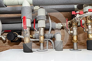 Open three-quarter inch valves attached to the heat pump installation, plastic elbows visible.