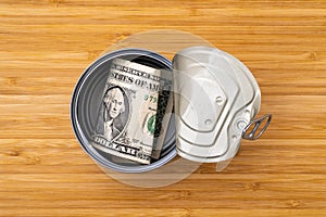 Open tin can with money of the USA