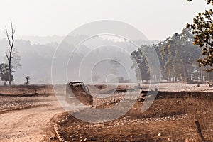 Open-top car on the field road. Competition off road and rough terrain. The Safari vehicles on the background of autumn road and t