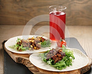 Open tortilla with beef, frillice, beans and corn