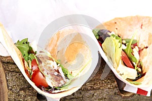 Open tortilla wrap with chicken breast and vegetables