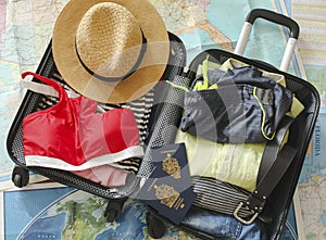 Open traveler`s bag with clothing, accessories, and passport. Travel and vacations concept