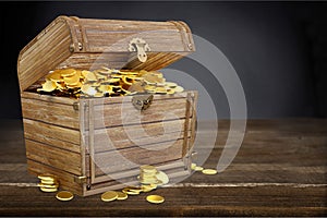 Open treasure chest filled with gold coins