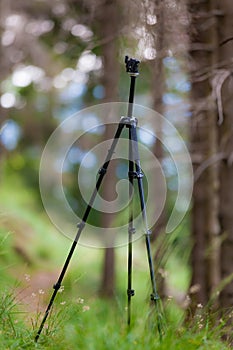 An open tripod, without mounted camera, in a summer mountain for