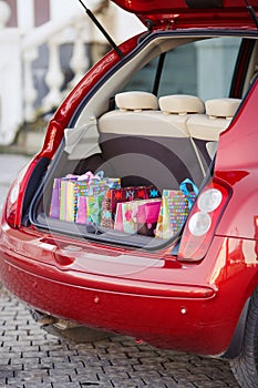 Open the trunk of the car with bags of purchases.