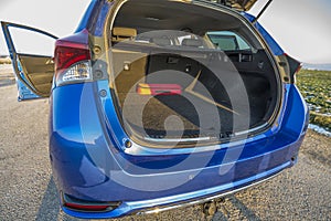 Open trunk door on a blue car