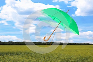 Open umbrella blown by wind gust outdoors