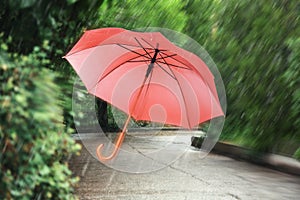 Open umbrella blown by wind gust outdoors