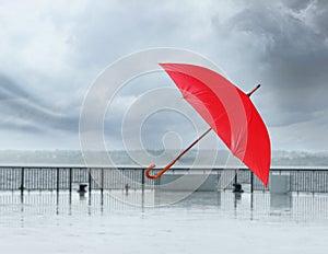 Open umbrella blown by wind gust outdoors