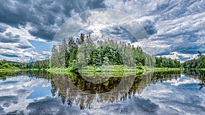 open view to the river of Gauja in Latvia with cloud reflections in water