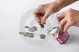 an open wallet with scattered coins in its hands on a white background