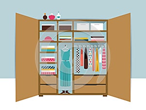 Open wardrobe. Wooden closet with tidy clothes, shirts, sweaters, boxes and shoes. Home interior