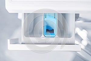 Open washing machine tray close up