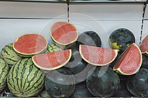 Open watermelons placed on different watermelon colours photo