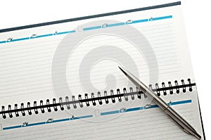 Open weekly planner with ballpen.