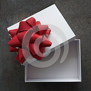 Open White Gift Box with Red Bow on Top