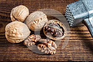 open and whole walnut close-up and hammer