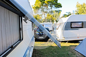 Open window of a camping trailer standing on a campsite in northern spain.