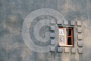 Open window in a dark blue plastered wall