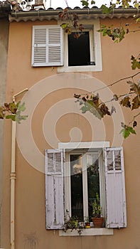 open window with flowers in an old french house