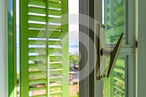 Open window with green wooden shutters with view of the Lovran, travel destination at Istrian seaside in Croatia