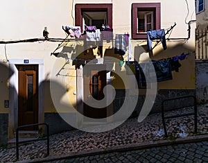 Open windows and linen. Ordinary stories of the old Lisbon. Portugal.