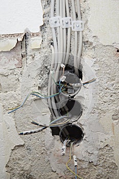 open wires in the interior and preparations for switches and sockets on a construction site