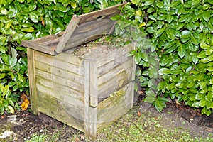 Open wooden compost ecological bin with organic material