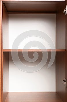 Open wooden wardrobe with empty shelves