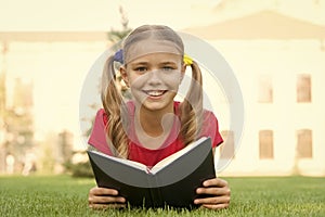 Open your imagination, read. Happy kid read book on green grass. Developing imagination. Childhood imagination