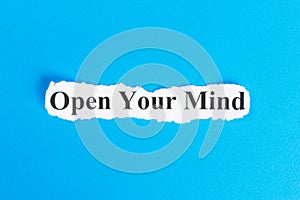 OPEN YOUR MIND text on paper. Word OPEN YOUR MIND on torn paper. Concept Image