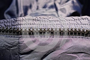 Open zip with black plastic teeth