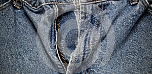 Open zipper on old faded jeans