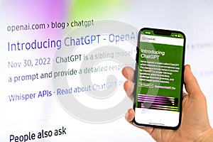 Openai chat gpt on mobile phone and computer in background