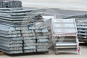 Openair storage of galvanized steel and aluminum frames, ladders, and ringlock scaffolding systems for many applications on